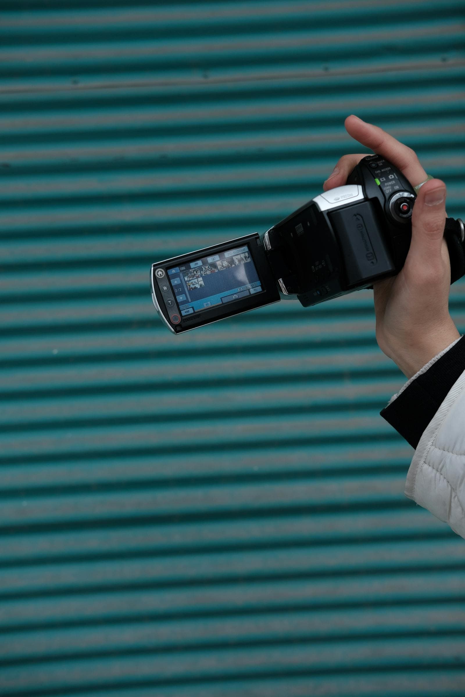 Sony Handycam camcorder with the LCD display open, held outdoors